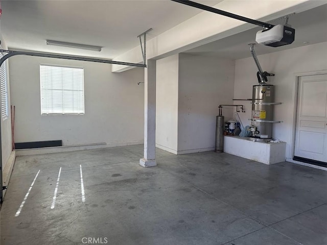 garage featuring a garage door opener and strapped water heater