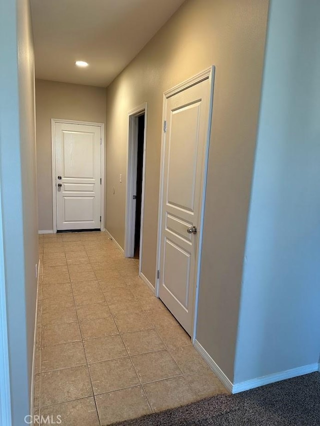 corridor featuring light tile patterned floors