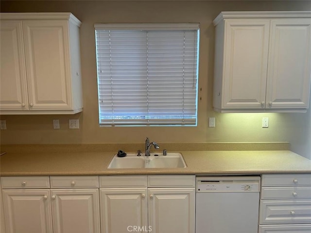 kitchen featuring dishwasher, white cabinets, and sink