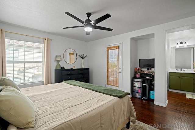 bedroom with ensuite bath, dark wood-type flooring, sink, access to outside, and ceiling fan