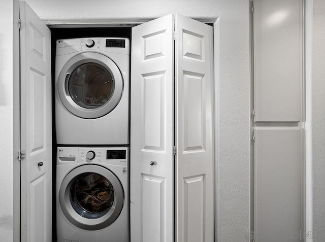 washroom with stacked washer and dryer