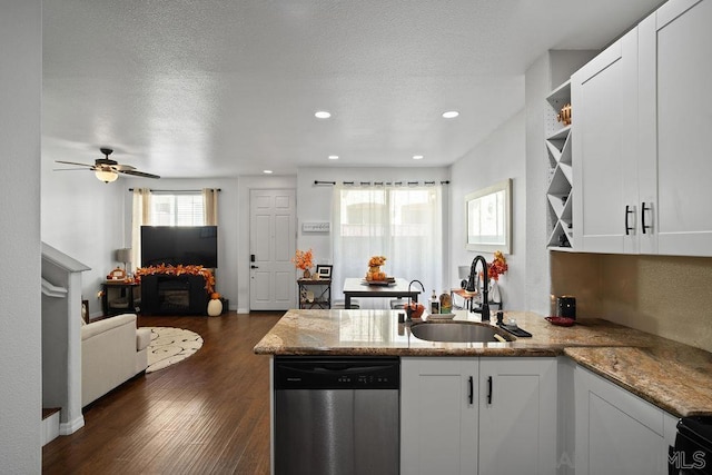 kitchen featuring light stone countertops, dishwasher, white cabinetry, dark hardwood / wood-style flooring, and sink