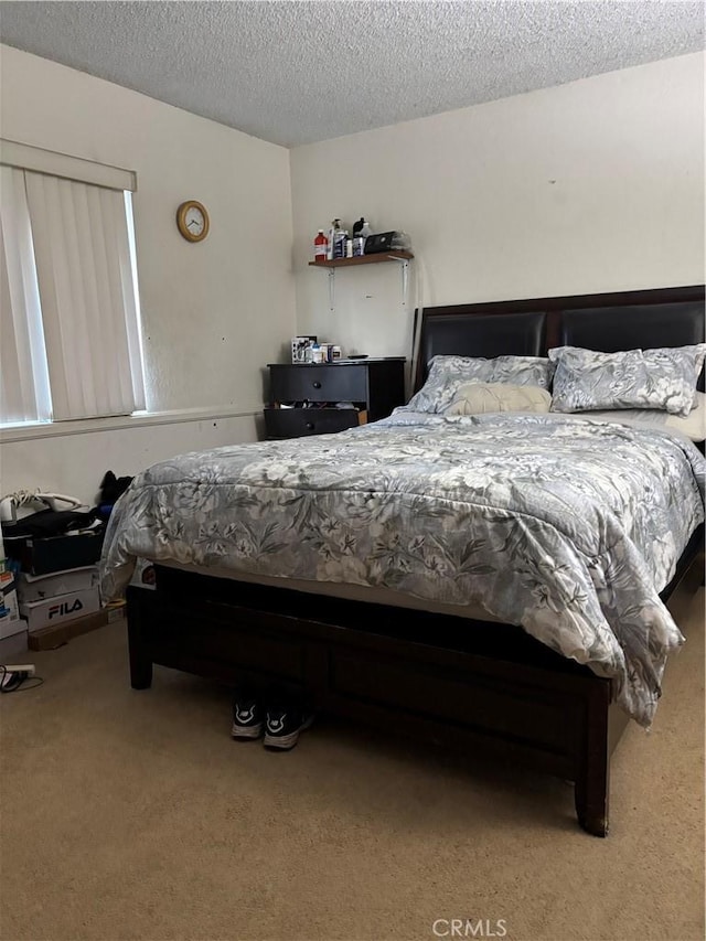 bedroom with carpet floors and a textured ceiling