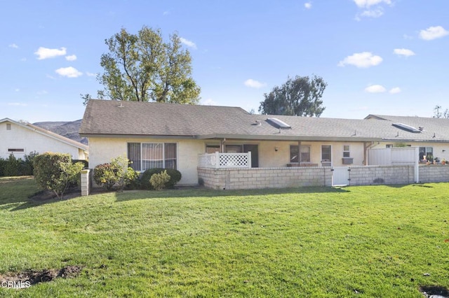 back of property featuring a lawn