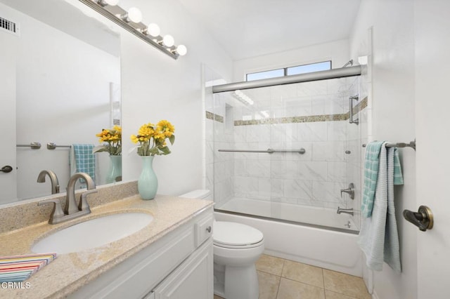 full bathroom with toilet, bath / shower combo with glass door, tile patterned flooring, and vanity