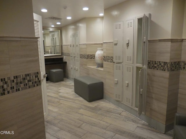 bathroom featuring tile walls and wood-type flooring