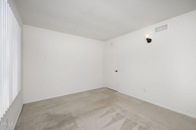 unfurnished room with light colored carpet