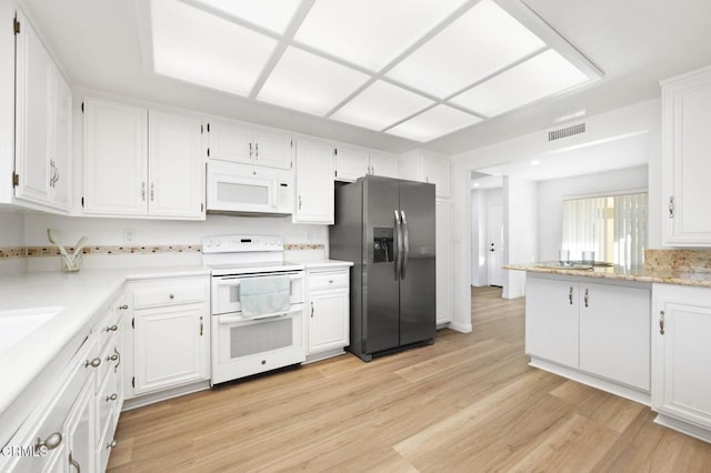 kitchen featuring light hardwood / wood-style flooring, white cabinets, and white appliances