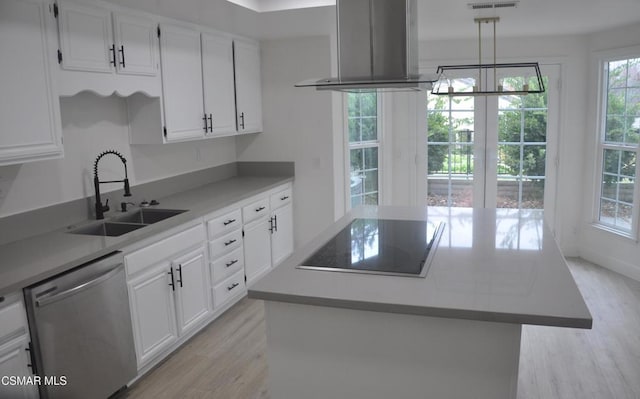 kitchen featuring sink, dishwasher, white cabinetry, range hood, and a center island