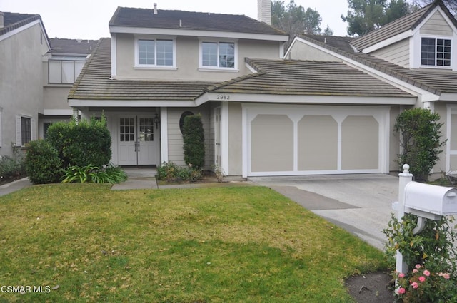 view of front of house with a garage and a front yard