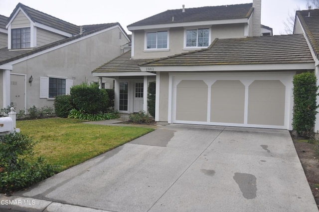 view of front of property featuring a garage and a front yard