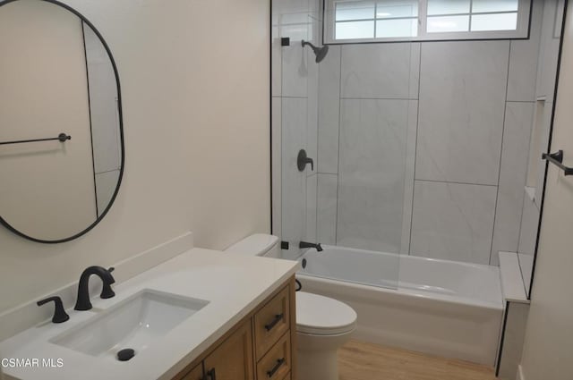 full bathroom featuring vanity, wood-type flooring, bathtub / shower combination, and toilet