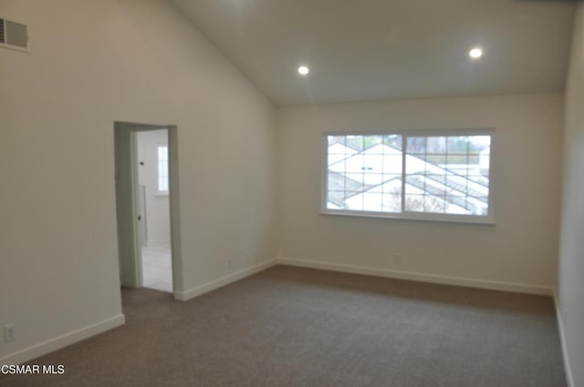 carpeted empty room with lofted ceiling and plenty of natural light