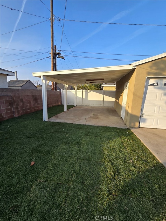 view of vehicle parking with a lawn and a carport