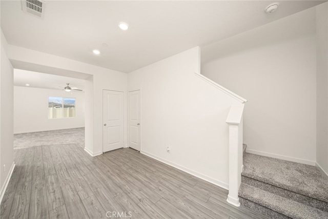 interior space with ceiling fan and light hardwood / wood-style floors