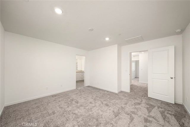 unfurnished room featuring light carpet