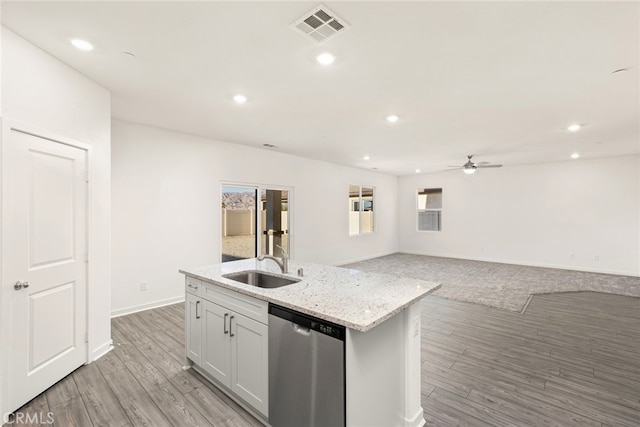 kitchen with sink, white cabinetry, light hardwood / wood-style floors, dishwasher, and a kitchen island with sink