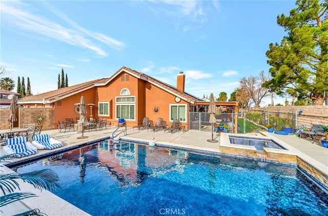 view of pool featuring a patio area and an in ground hot tub