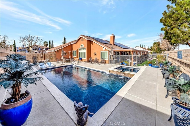 view of pool featuring an in ground hot tub and a patio area