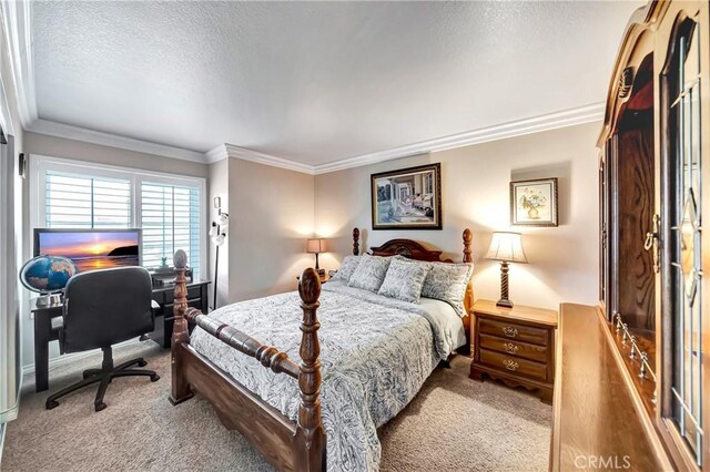 carpeted bedroom featuring crown molding and a textured ceiling