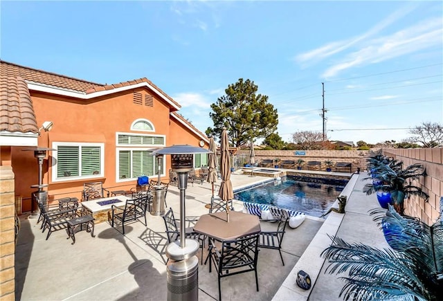 view of pool featuring an outdoor fire pit and a patio