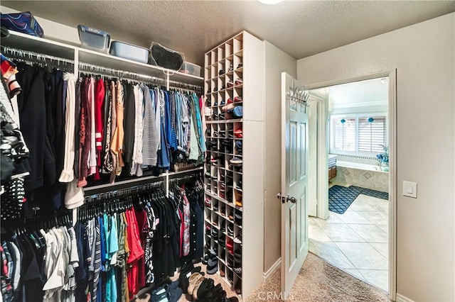 spacious closet featuring tile patterned flooring