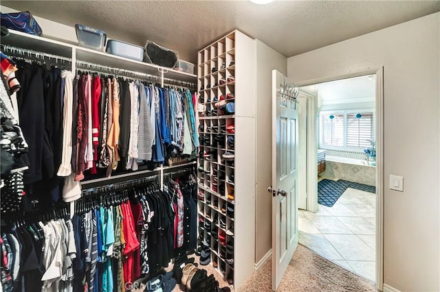 spacious closet featuring tile patterned floors