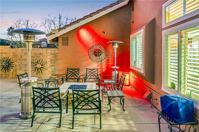 view of patio terrace at dusk