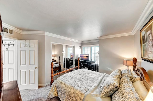 bedroom with crown molding and carpet flooring