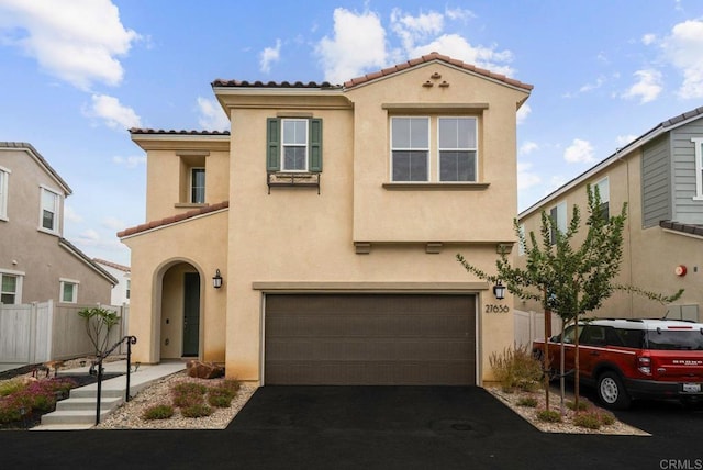 mediterranean / spanish-style home with a garage