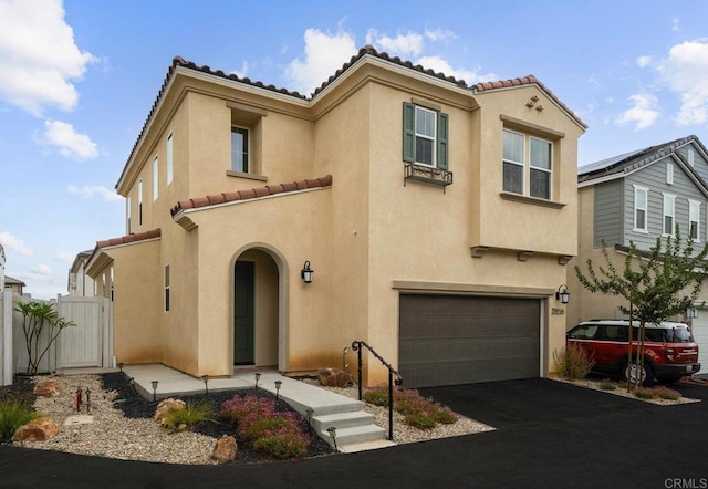 mediterranean / spanish house featuring a garage