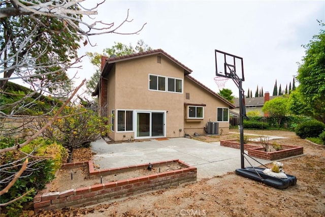 rear view of property featuring a patio and central air condition unit