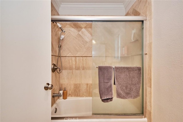 bathroom with ornamental molding and shower / bath combination with glass door