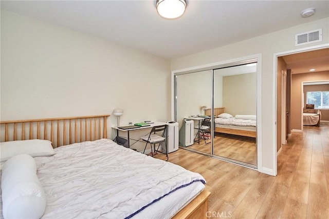 bedroom with a closet and light wood-type flooring