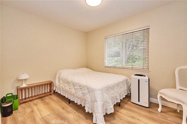 bedroom with hardwood / wood-style floors