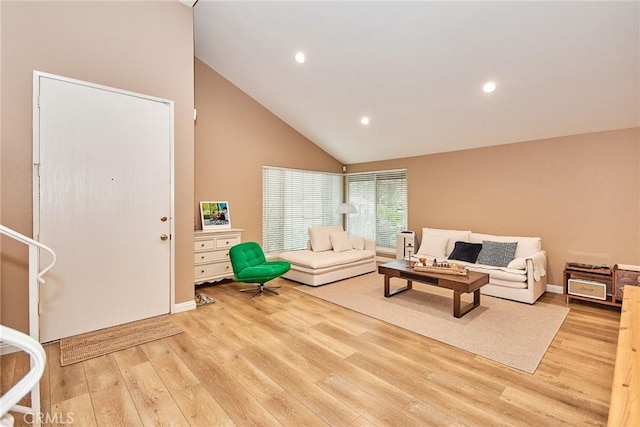 living room featuring high vaulted ceiling and light wood-type flooring