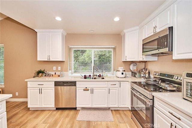 kitchen featuring white cabinetry, sink, and stainless steel appliances