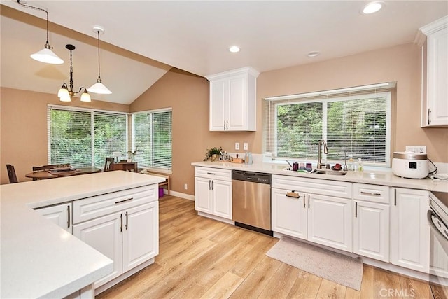 kitchen featuring pendant lighting, dishwasher, sink, white cabinets, and an inviting chandelier