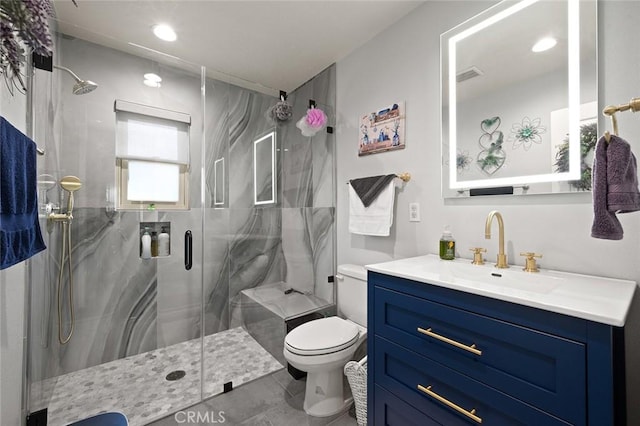 bathroom featuring an enclosed shower, vanity, and toilet