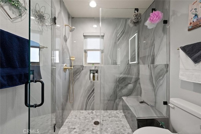 bathroom with toilet and walk in shower