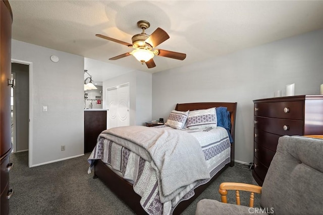 bedroom featuring ceiling fan and dark carpet