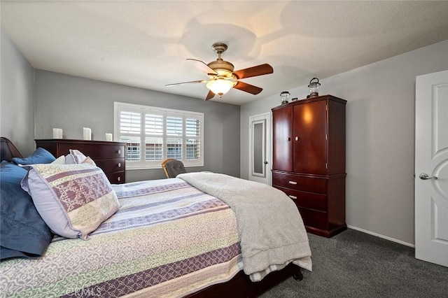 bedroom with ceiling fan and dark carpet