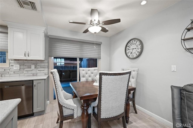 dining area with ceiling fan and light wood-type flooring