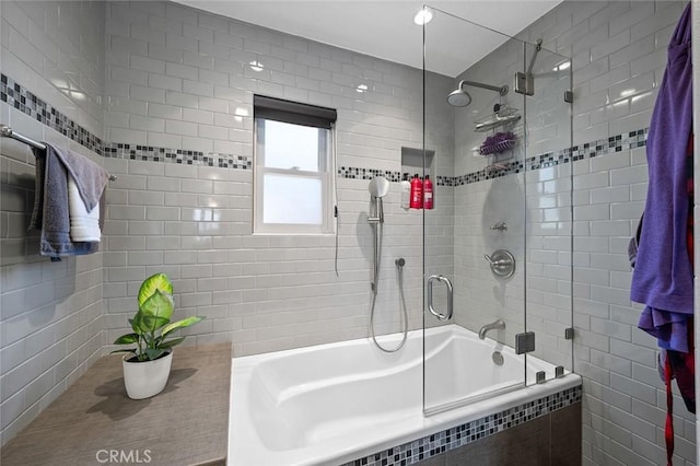 bathroom featuring shower / bath combination with glass door