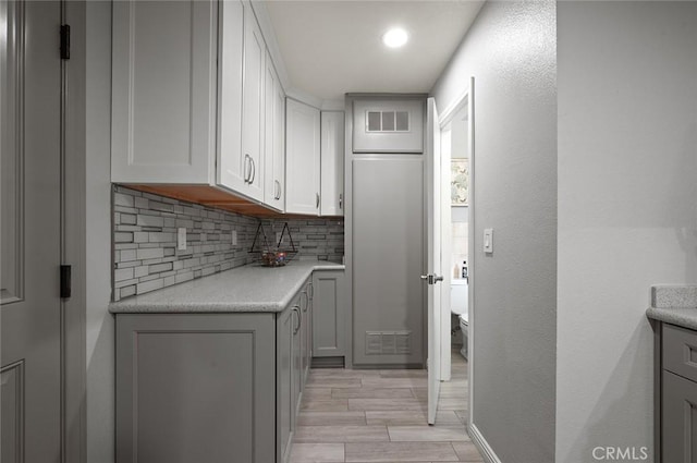 kitchen featuring decorative backsplash and light hardwood / wood-style flooring