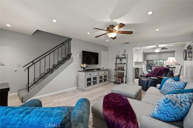 living room featuring ceiling fan and light wood-type flooring