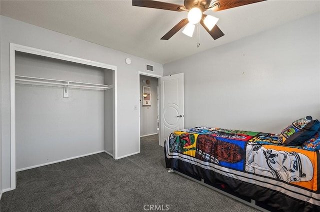 carpeted bedroom with ceiling fan and a closet