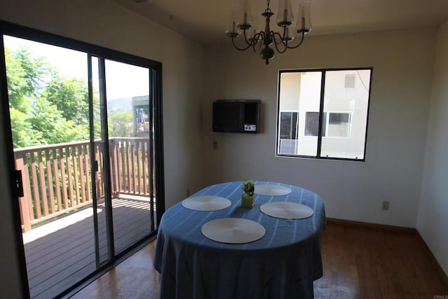 dining space featuring hardwood / wood-style flooring and a chandelier