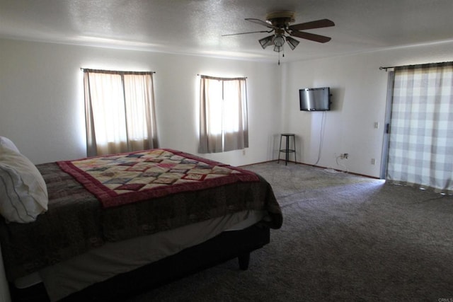 carpeted bedroom featuring ceiling fan and a textured ceiling