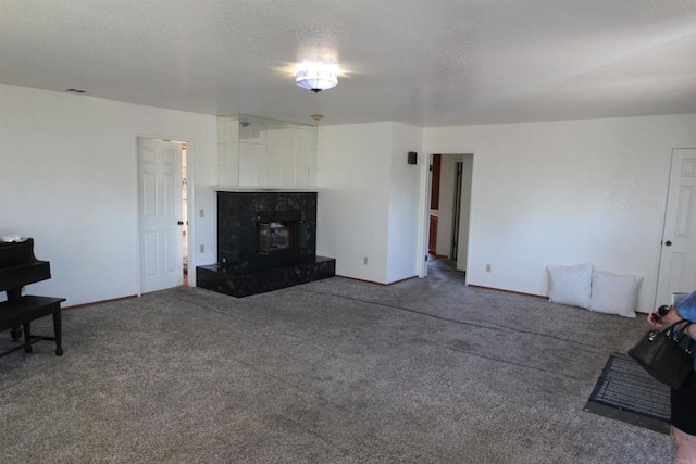 unfurnished living room with a wood stove and carpet flooring